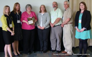SOA President Judith Wiener presenting Merit Award to OHRAB member Janet Carleton, accepting on behalf of the Ohio Historical Records Advisory Board, May 21, 2014. Others in photo are past or present OHRAB members (Laurie Gemmill Arp, Carleton, Dawne Dewey, Ron Davidson, George Bain). At right is Jillian Carney, OHS staff member who facilitates the board's work and Council liaison to the Awards Committee.